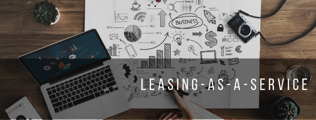 A desk with a laptop and a hand-drawn business plan, captioned “Leasing-as-a-service”